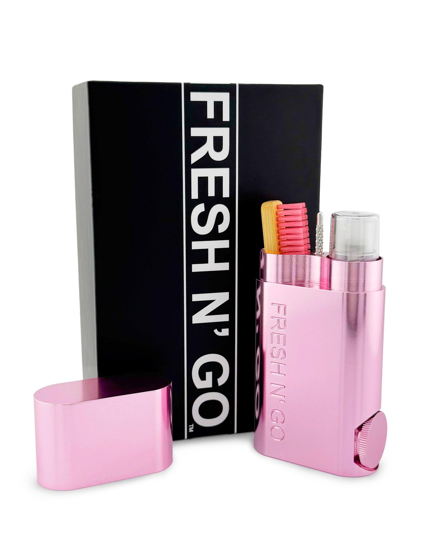 Compact pink toothbrush and toothpaste kit open with box