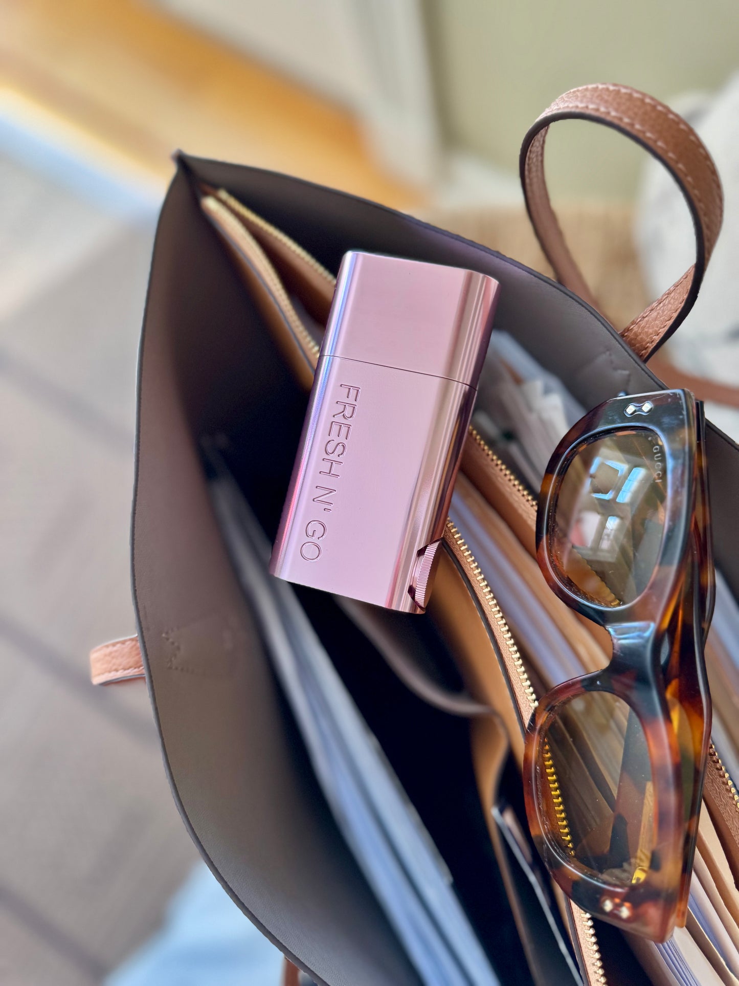 Stylish pink oral care kit for women on work bag with sunglasses