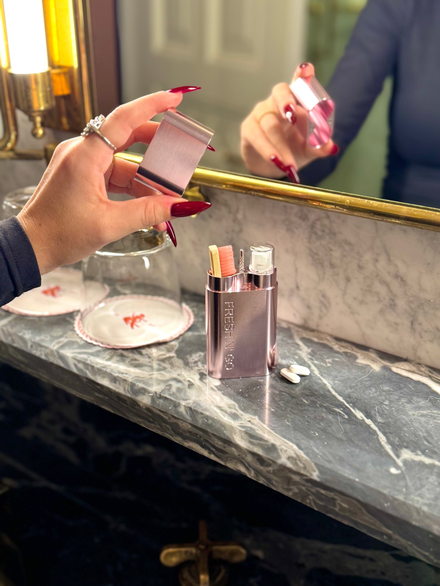 Chic pink travel toothbrush kit displayed on hotel vanity