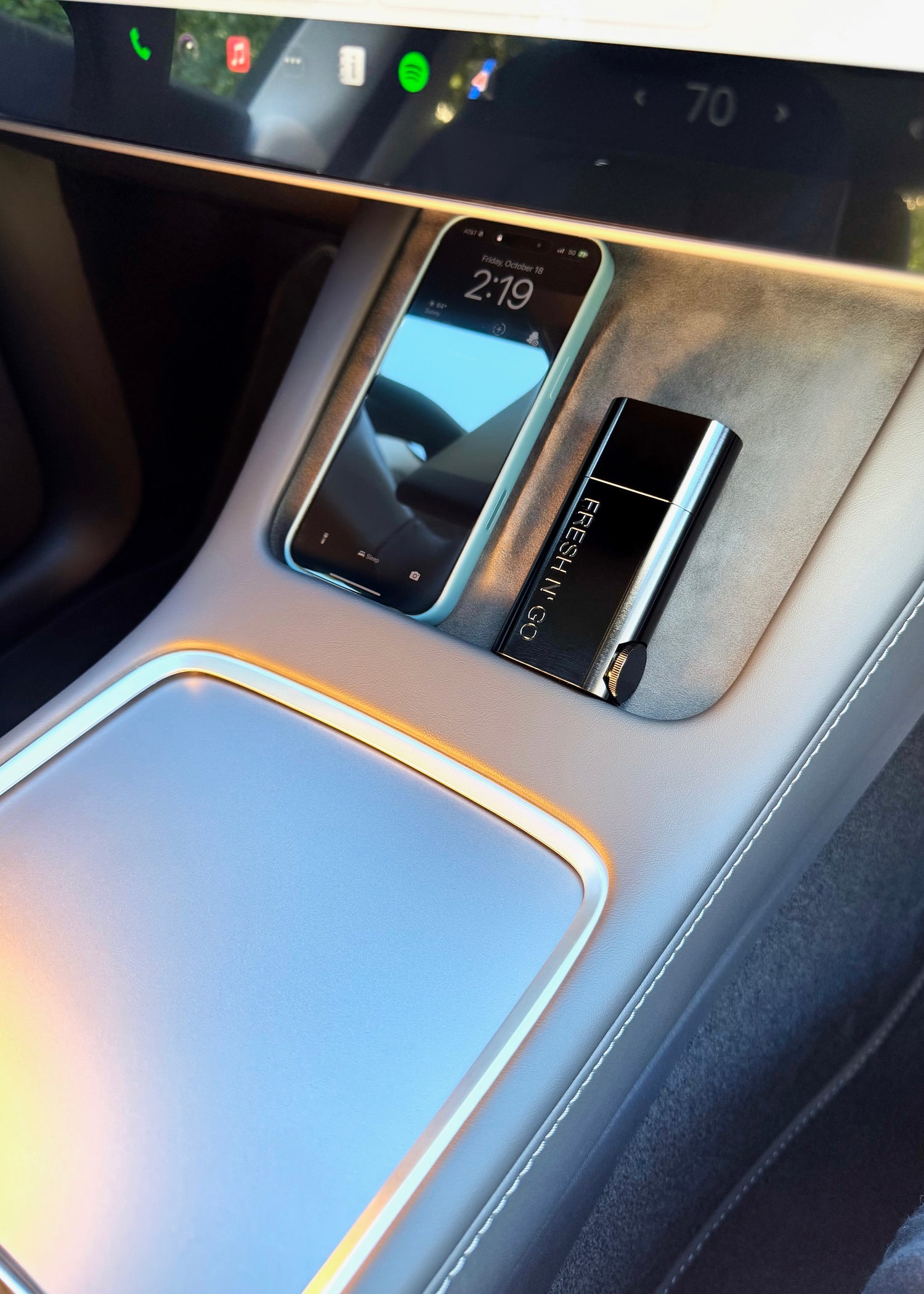 Midnight Black FRESH N’ GO Kit in Tesla console next to iPhone